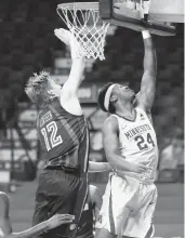  ?? ASSOCIATED PRESS
STACY BENGS/ ?? Minnesota’s Eric Curry, right, drives to the basket against Saint Louis’s Marten Linssen during a game in Minneapoli­s. Curry and other college athletes are finding creative ways to keep family close during the holidays.