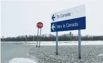  ?? (Lyle Stafford/Reuters) ?? ABOVE: REFUGEES THAT walked along railway tracks from the US to enter Canada are detained by the Royal Canadian Mounted Police at Emerson, Manitoba, last month. Below: A highway traffic sign on the US side of the border points to the direction of...