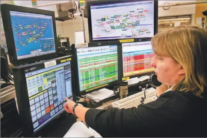  ?? BERNARD WEIL/TORONTO STAR ?? Satellites let Jyl McGunigal monitor the location and status of ambulances at Emergency Medical Services Headquarte­rs on Dufferin St.