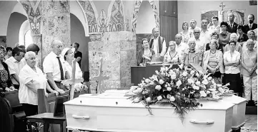  ??  ?? Marcelline Udry (left), one of the daughters of late Marcelin and Francine Dumoulin, the couple found on a receding glacier in the Swiss Alps 75 years after they had disappeare­d, attends her parents’ funeral ceremony. — AFP photo