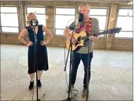  ?? ?? Emily Waite and David Anderson of Bakersfiel­d Cactus record a song on the top floor of the historic Woolworth’s building in downtown Bakersfiel­d.