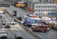  ?? SETH WENIG, FILE — THE ASSOCIATED PRESS ?? In this Dec. 27photo, emergency personnel work at the scene of a fatal multi-vehicle crash on the eastbound side of the Bronx Expressway in the Bronx section of New York. The government says traffic fatalities surged about 8 percent in the first nine...