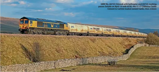  ?? PAUL A BIGGS ?? GBRf No. 66723 Chinook with helicopter and ZA723 marking passes Selside on April 14 with 6C00, the 17.17 Clitheroe Castle Cement to Carlisle loaded cement tanks.