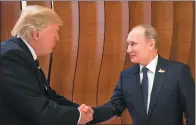  ?? STEFFEN KUGLER / REUTERS ?? US President Donald Trump and Russian President Vladimir Putin shake hands during the G20 Summit in Hamburg, Germany, on Friday.