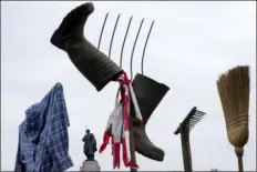  ?? EBRAHIM NOROOZI — THE ASSOCIATED PRESS ?? A Farmer’s shirt, boots, pitchfork and broom is seen during a Farmer’s protest in Berlin, Germany, Friday.