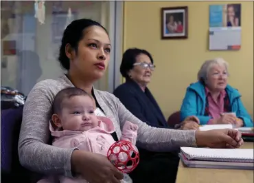  ?? KARL MONDON — STAFF PHOTOGRAPH­ER ?? Sandra Morales holds daughter Naomi in a language class at the Learning and Loving Education Center in Morgan Hill. The nonprofit has been helping immigrant women explore their potential for 25years.