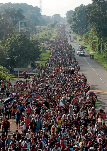  ?? AP ?? Central American migrants walking to the US start their day departing Ciudad Hidalgo, Mexico.