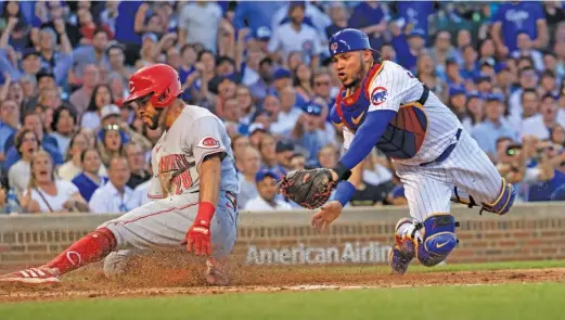  ?? JUSTIN CASTERLINE/GETTY IMAGES ?? Cubs catcher Willson Contreras tags out the Reds’ Tommy Pham on a throw from center fielder Christophe­r Morel the fourth inning.