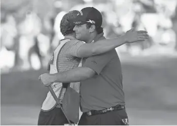  ?? ERIC SUCAR, USA TODAY SPORTS ?? Patrick Reed, right, hugs caddie Kessler Karain after his breakout victory Sunday.