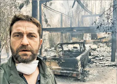  ??  ?? ALL THAT REMAINS: Actor Gerard Butler posted this selfie Sunday in front of his home in Malibu. It was destroyed by one of California’s devastatin­g wildfires, which have killed at least 31 people.