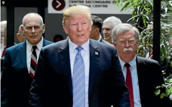  ?? AP ?? US President Donald Trump leaves the G7 Leaders Summit in La Malbaie, Quebec, with White House Chief of Staff John Kelly, left, and National Security Adviser John Bolton.