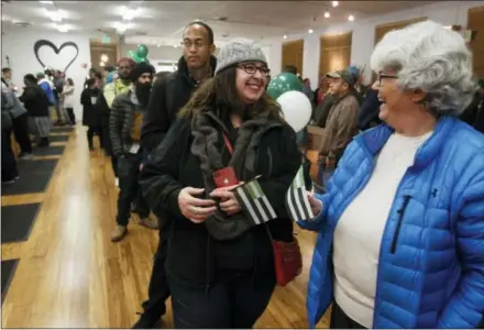  ?? MATHEW SUMNER — THE ASSOCIATED PRESS ?? Margot Simpson, right, and Diana Gladden wait in line to purchase marijuana at Harborside marijuana dispensary, Monday in Oakland, California. Starting New Year’s Day, recreation­al marijuana can be sold legally in California.