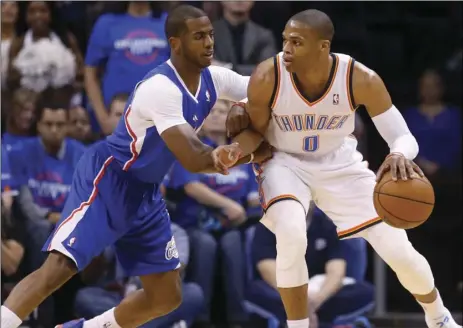  ?? AP PHOTO/SUE OGROCKI ?? In this May 5, 2014, file photo, Oklahoma City Thunder guard Russell Westbrook (0) drives against Los Angeles Clippers guard Chris Paul (3) in the first quarter of Game 1 of the Western Conference semifinal NBA basketball playoff series in Oklahoma City.