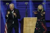  ?? ANDREW HARNIK-ASSOCIATED PRESS ?? President-elect Joe Biden and wife Jill Biden gesture to supporters Saturday in Wilmington, Del.