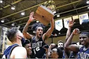  ?? CHARLES KRUPA / AP ?? Mount St. Mary’s guard Damian Chong Qui hoists the trophy as his team celebrates winning the Northeast Conference tournament Tuesday in Smithfield, R.I. Now the teams travels to Indianapol­is.