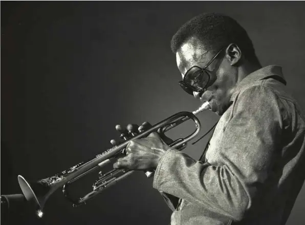  ?? Jack Vartoogian / Getty Images ?? Miles Davis plays the trumpet in New York in 1969. The renowned jazz musician, who died in 1991, is portrayed by Don Cheadle in the new film “Miles Ahead.” Cheadle also directed the film, which is structured around a fictitious interview with a...