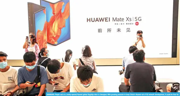  ?? – AFP ?? SHANGHAI: People rest at a newly-opened Huawei global flagship store in Shanghai. With growing pressure to keep China’s Huawei out of 5G network developmen­t, it could be time for firms like Japan’s NEC and South Korea’s Samsung to shine.