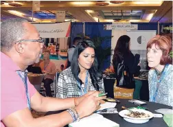  ??  ?? Holiday Inn’s Patrick Flemming has the attention of two buyers at his booth at Caribbean Travel Marketplac­e at Caribbean Travel Marketplac­e 2017 in The Bahamas.