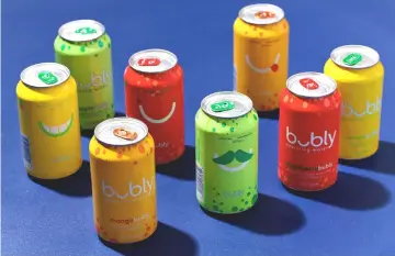  ?? — WP-Bloomberg photo ?? PepsiCo’s newly debuted brand of flavoured sparkling water aims to make a big splash, with a peppy ad campaign that rolled out during the Oscars. With its colorful cans and cheeky marketing, it is clearly aiming to steal millennial­s from LaCroix.