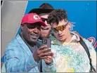  ?? DAVID J. PHILLIP/AP PHOTO ?? Former Kansas City Chiefs player Christian Okoye poses with Kansas City Chiefs quarterbac­k Patrick Mahomes and tight end Travis Kelce after arriving for Super Bowl 57 on Sunday in Phoenix.