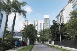  ??  ?? Moderate increase: A jogger runs past condominiu­ms in the Newton area of Singapore. The government will continue to monitor economic and property market conditions closely. — Bloomberg