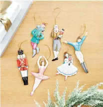  ??  ?? Ballard Designs’ Nutcracker collection includes handmade, hand-painted ornaments based on the iconic holiday ballet.