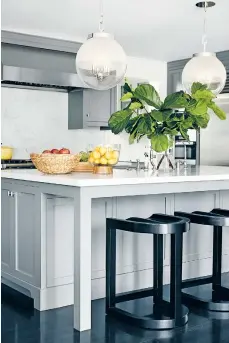  ?? CHRISTOPHE­R PATEY/BETSY BURNHAM VIA AP ?? A kitchen in a Pasadena, Calif., home designed by Betsy Burnham. One key to planning a great island, Burnham says, is leaving plenty of legroom for barstool seating along one side.