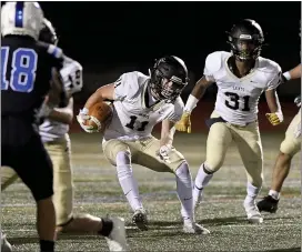  ?? BEN HASTY — READING EAGLE ?? Berks Catholic’s Christian Cacchione runs the ball in front of teammate Josiah Jordan (31) during a game last year. Both are expected to play leading roles in the Saints’ offense this year.