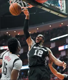  ?? AP PHOTO/ERIC CHRISTIAN SMITH ?? San Antonio Spurs forward LaMarcus Aldridge (12) dunks as Houston Rockets centre Clint Capela (15) watches during the second half in Game 6 of an NBA basketball second-round playoff series, Thursday in Houston.