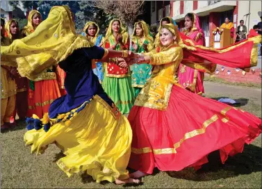  ?? AFP ?? Students wearing traditiona­l Punjabi dresses perform the Giddha dance during celebratio­ns on the occasion of the Lohri festival in Amritsar on Friday.