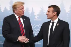  ??  ?? Trump shakes hands with Macron during a bilateral meeting at the G7 Summit in Charlevoix, Quebec, Canada. — Reuters photo