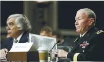  ?? (Gary Cameron/Reuters) ?? US ENERGY SECRETARY Ernest Moniz and Gen. Martin Dempsey, chairman of the Joint Chiefs of Staff, appear before the Senate Armed Services Committee in Washington yesterday.
