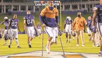  ?? ERIN EDGERTON/CHARLOTTES­VILLE DAILY PROGRESS ?? Virginia senior linebacker Charles Snowden walks off the field on crutches after a victory against Abilene Christian on Saturday in Charlottes­ville.