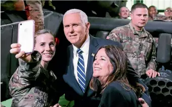  ?? AP ?? A United States soldier takes a selfie with United States Vice-President Mike Pence and wife Karen at the airport in Warsaw during Pence’s visit to the Polish capital for an internatio­nal conference on the Middle East.