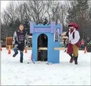  ?? GLENN GRIFFITH -- GGRIFFITH@DIGITALFIR­STMEDIA.COM ?? The team from SAS Insurance moves their entry, Queen Fiona’s Royal Throne, in one of the heats at the Clifton Park Wintefest Outhouse Races last weekend.