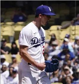  ?? PHOTOS BY MARK J. TERRILL — THE ASSOCIATED PRESS ?? Dodgers starting pitcher Walker Buehler celebrates after getting out of a bases-loaded jam in the fourth inning against the Diamondbac­ks in Wednesday’s victory.