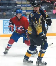  ?? NEWS PHOTO RYAN MCCRACKEN ?? Writer Scott Schmidt (not wearing the Canadiens jersey) skates alongside ex-Montreal player Gilles Thibaudeau during an alumni tour game Saturday at the Canalta Centre.