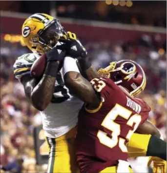  ?? MARK TENALLY — THE ASSOCIATED PRESS ?? Green Bay tight end Martellus Bennett (80) pulls in a TD pass under pressure from Redskins linebacker Zach Brown (53) during a preseason game in Landover, Md.