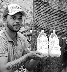  ?? ?? Rubber tapper Rogerio Mendes shows off his Veja sneakers, received as a prize for his work as a young rubber extractor in the Chico Mendes Extractive Reserve, Acre state, Brazil, Wednesday, December 7, 2022.