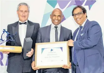  ??  ?? THE CHIEF executive of Kagiso Asset Management, Roland Greaver (centre), receives the Chairman’s Raging Bull Award for the Black Manager of the Year from Martin Hesse, the content editor of Personal Finance, and Dr Iqbal Survé, the chairman of Independen­t Media.