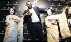  ?? — AP ?? KYOTO: Usain Bolt of Jamaica gestures with maiko, or an apprentice geisha, during a promotiona­l event in Kyoto, western Japan, yesterday. Bolt says he has no regrets about retiring and is confident his world records will stand for at least another 15...