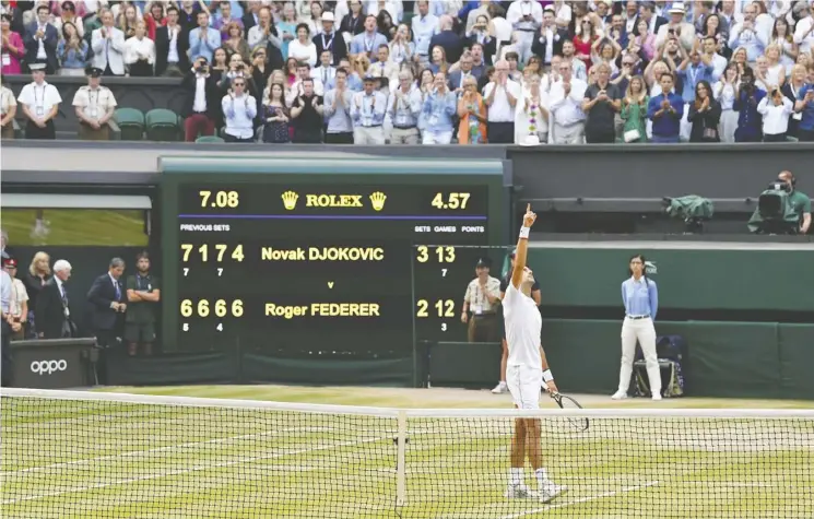  ??  ?? Novak Djokovic celebrates his five-set win over Switzerlan­d’s Roger Federer on Sunday, which sealed the Serb’s fifth Wimbledon title and 16th Grand Slam crown.
Toby Melville/reuters