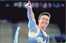  ?? USA Today Sports — Danielle Parhizkara­n ?? Brody Malone points to the crowd after completing the parallel bars during the men’s individual all-around final Wednesday in Tokyo. The Summervill­e native finished 10th overall, a few spots ahead of American teammate Sam Mikulak.