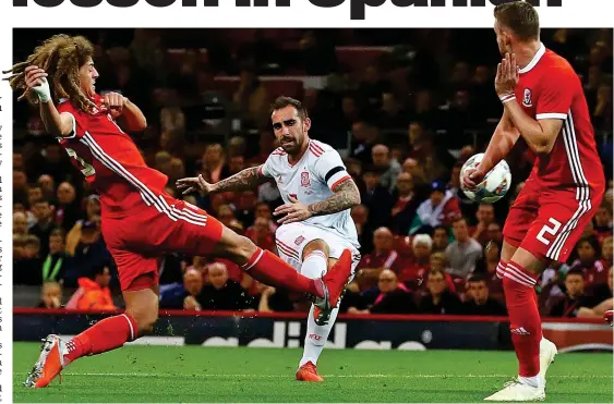  ?? BPI/REX ?? Early setback: Alcacer curls the ball home after only eight minutes as Spain proved too strong for Wales last night