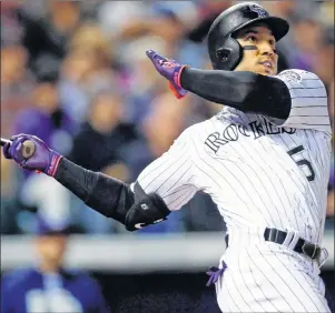  ?? AP PHOTO ?? In this Sept. 16 file photo, Colorado Rockies’ Carlos Gonzalez follows the flight of his two-run home run off San Diego Padres starting pitcher Jordan Lyles in the fifth inning of a baseball game in Denver.