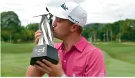  ?? AFP ?? Justin Thomas kisses the trophy after winning the 2016 CIMB Classic golf tournament in Kuala Lumpur on Sunday. —