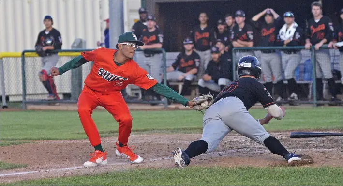  ?? STEVEN MAH/SOUTHWEST BOOSTER ?? Swift Current 57’s pitcher Diego Jordan (left) tagged Fort Mcmurray’s Nick Carlini during a rundown on Thursday.