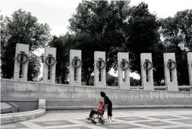  ?? Lisa Krantz / Staff file photo ?? Judy Wilson pushes WWII veteran Imogene Hill around the National World War II Memorial in 2010 with the Alamo Honor Flight in Washington.