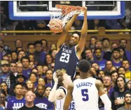  ?? Lance King / Getty Images ?? Yale’s Jordan Bruner dunks over Duke’s Alex O’Connell and RJ Barrett (5) at Cameron Indoor Stadium on Saturday in Durham, N.C.