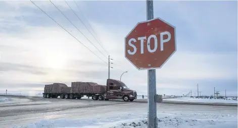  ?? CP PHOTO ?? A truck goes through the intersecti­on near the memorial for the 2018 crash where 16 people died and 13 injured when a truck collided with the Humboldt Broncos hockey team bus, at the crash site on January 30, 2019, in Tisdale, Sask.